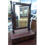 An early Victorian toilet mirror, the plate pivoting on angled, ring turned horns and a twin,