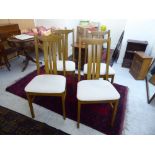 A set of four modern teak framed lath back dining chairs,