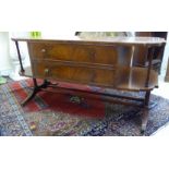 A mid 20thC Georgian inspired coffee table, the shaped top with three tooled hide panels,