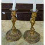 A pair of late Victorian gilt metal Rococo design candlesticks,