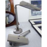 A pair of Waldmann fully adjustable workroom lamps,