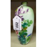 A 20thC enamelled vase of slender baluster form, decorated in colours with mixed flora,