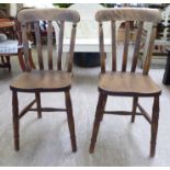 A pair of early 20thC beech and elm framed lath back dining chairs,