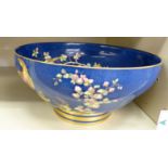 An early 20thC Spode china fruit bowl, decorated with peacocks amongst flora, on a blue ground,