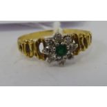 An 18ct gold emeralds and diamond set cluster ring 11