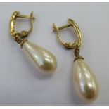 A pair of yellow metal simulated pearl drop earrings 11