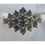 A gold coloured metal claw set diamond cluster ring 11