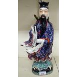 A mid 20thC Chinese porcelain figure, a robed man, on a plinth 14.
