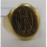 A gold coloured metal signet ring 11