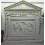 A 19thC classically inspired, moulded, faux plaster chimneypiece with a painted, arched top,