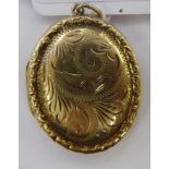 A 9ct gold oval locket with foliate ornament 11