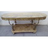 A modern Italianate lacquered brass and onyx oval two tier coffee table on standing figural