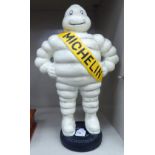 A painted cast iron figure, the Michelin Man standing on a tyre 14.