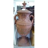 A terracotta finished, twin handled terrace urn of bulbous form, decorated with moulded, trailing,