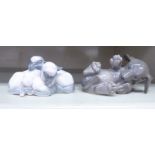 A Royal Copenhagen porcelain model, a playful puppy no.1408 2.5''h; and two lambs no.2769 2.