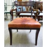 A Regency mahogany framed elbow chair with a curved reed carved bar crest and horizontal splat,