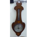 An Edwardian satinwood and ebony string inlaid mahogany backed onion topped banjo shaped aneroid