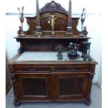 An early 20thC French carved and veneered walnut chiffonier,