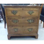An early 20thC light oak chest, the three graduated long drawers with cast brass bail handles,