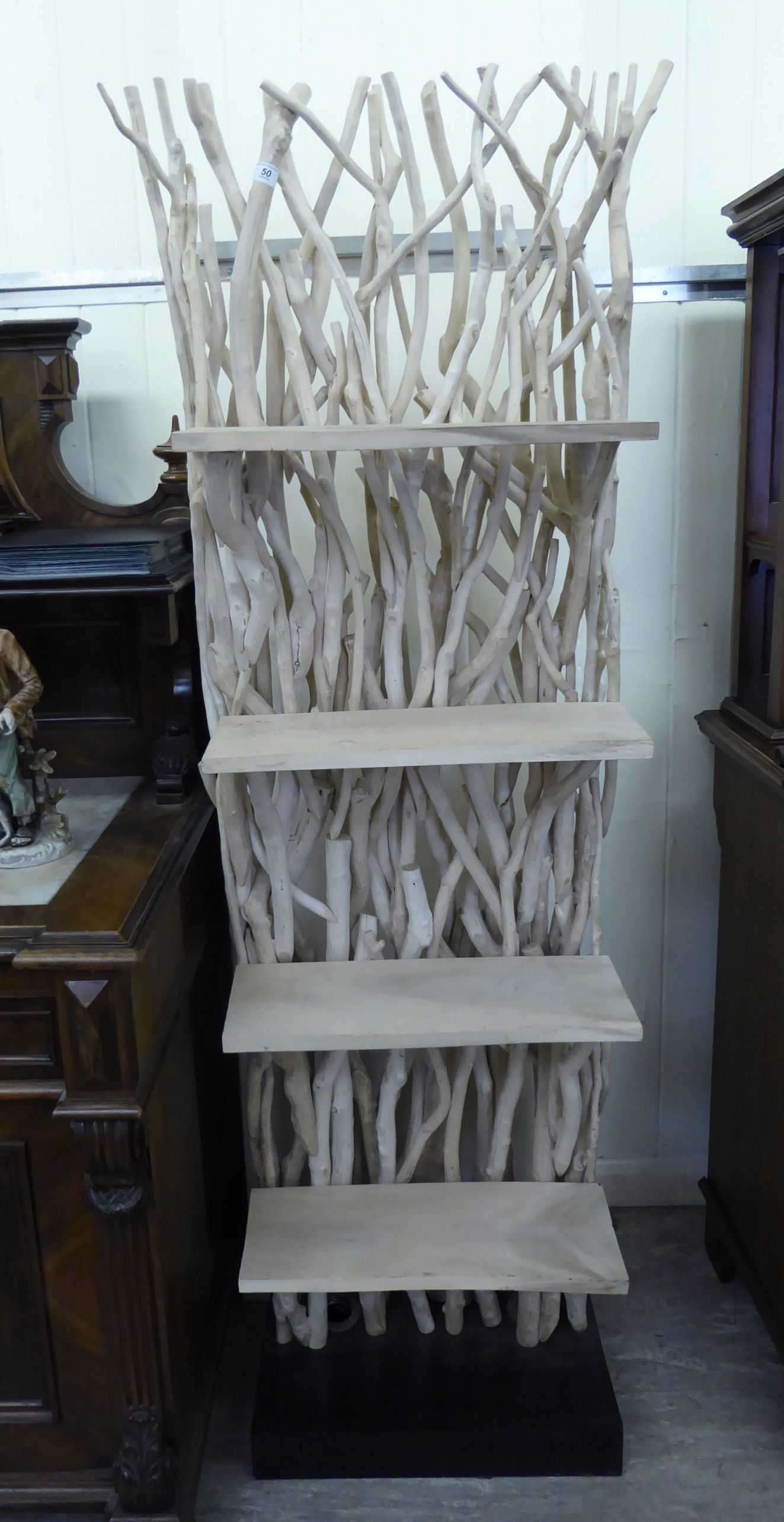 A simulated driftwood display stand with four fixed shelves,