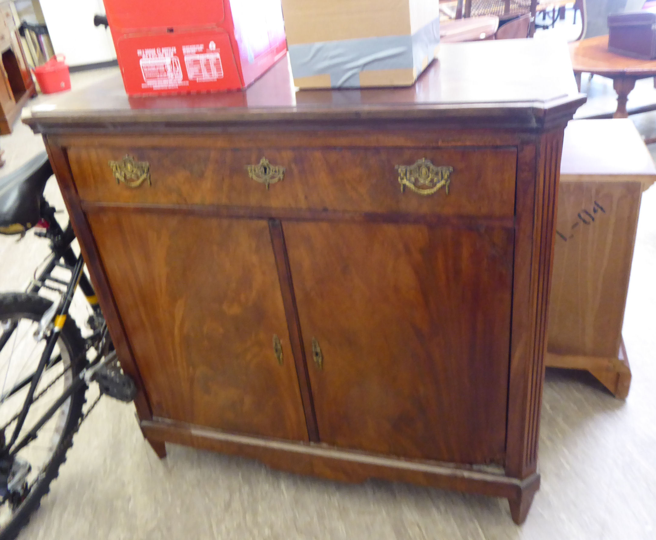 A mid 19thC Dutch flame veneered mahogany sideboard, the top with outset canted corners,