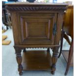 A late 19th/early 20thC Continental oak pot cupboard with a mitred top and a reed carved frieze,