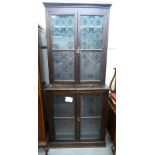 An early 20thC mahogany finished cabinet bookcase with two pairs of glazed panelled doors,