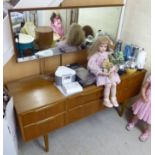 A mid 20thC teak and other dressing table, the elongated rectangular mirror over six drawers,