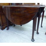 A 1920s reproduction of a Georgian mahogany drop leaf dining table,
