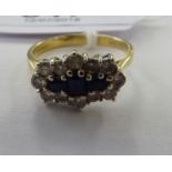 An 18ct gold sapphire and diamond set cluster ring 11