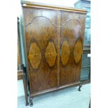 A 1920/30s walnut bedroom suite, comprising a wardrobe with two full height doors,