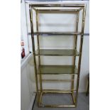 A modern brass display stand with three tinted glass shelves 70''h 29''w F