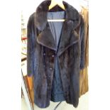 A knee-length black mink coat with bead decorated buttons and monogrammed lining S