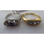 An 18ct gold five stone diamond ring; and a white metal ring,