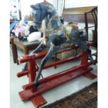 An early 20thC blue and red painted wooden nursery rocking horse,
