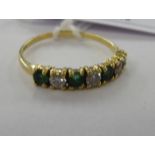 A gold coloured metal half eternity ring,