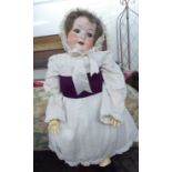 An early 20thC Heubach Koppelsdorf bisque head doll with painted features and weighted sleeping