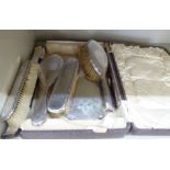 A six piece silver backed dressing table set with floral and ribbon tied ornament comprising a