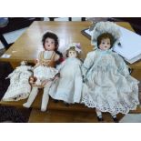 Four early 20thC bisque head dolls: to include a Simon & Halbig,