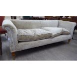 A modern 'Recline & Sprawl' three seater settee, upholstered in biscuit coloured,