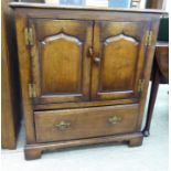 A Titchmarsh & Goodwin Old English style oak television cabinet, fashioned as a cupboard,