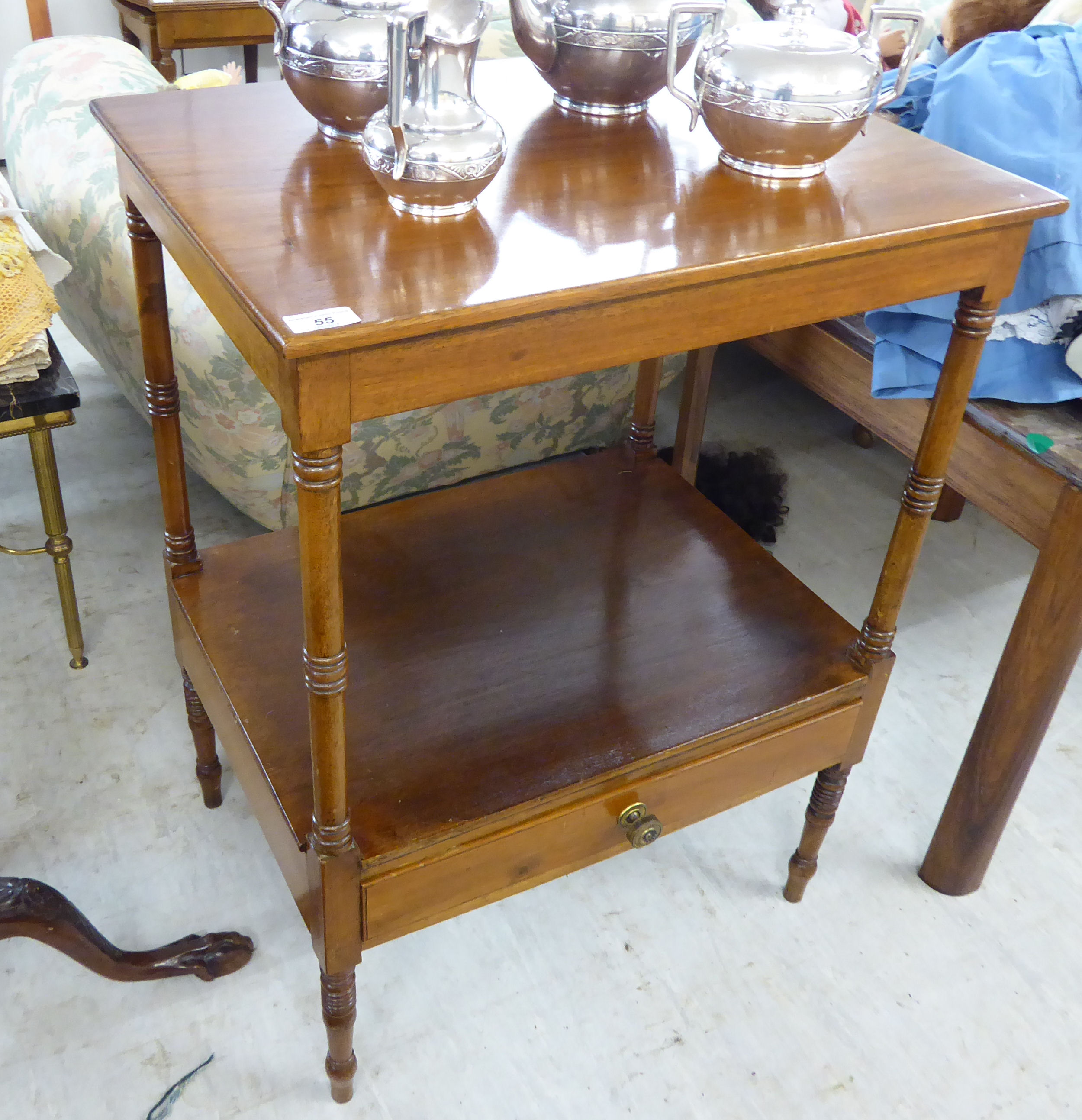 A mid/late Victorian mahogany two tier hall table with a single drawer, raised on ring turned,