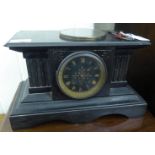 A late Victorian black slate cased mantle clock with a platform top,