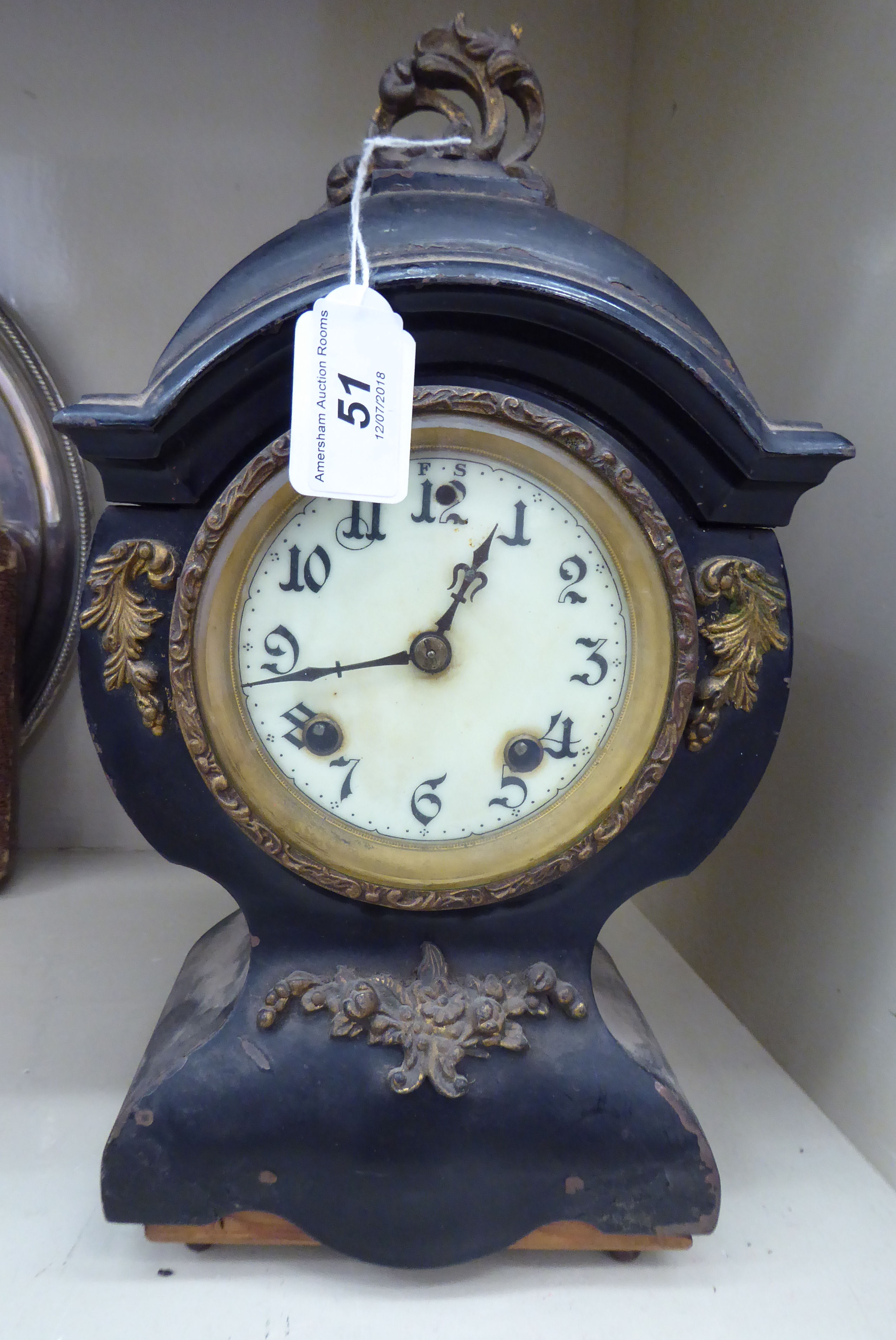 A late 19thC French black enamelled steel balloon cased and gilt metal mounted mantle clock;