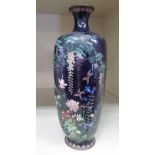 An early 20thC Japanese cloisonne vase of tapered and panelled baluster form,