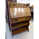 An Edwardian Arts and Crafts inspired satinwood and ebony inlaid oak student's bureau with a fall