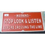 A cast iron sign 'Stop, Look & Listen....