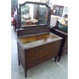 An Edwardian mahogany three drawer dressing chest, raised on square,