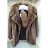 A three-quarter length mid-brown mink jacket; and a matching Boutique Kates,