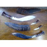 Two early 20thC kukris, one with two skinning knives,